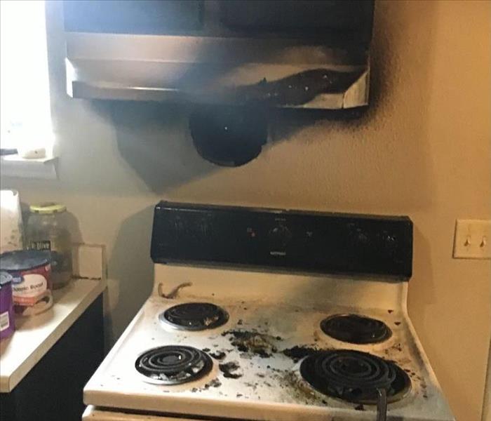 burned cabinets and stove after a kitchen fire