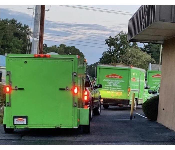 Servpro of Greater Northern Charleston trucks lined up leaving our office 