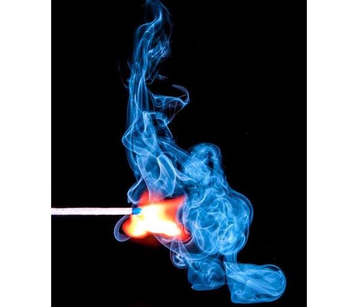 match with flame and blue and white smoke